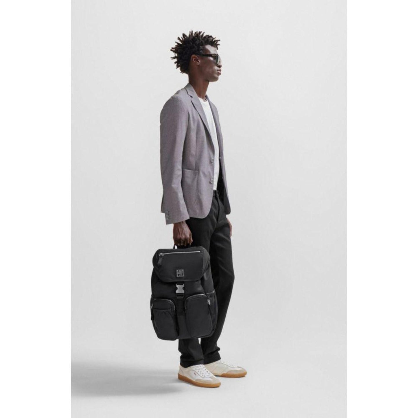 Flap-closure backpack with logo patch