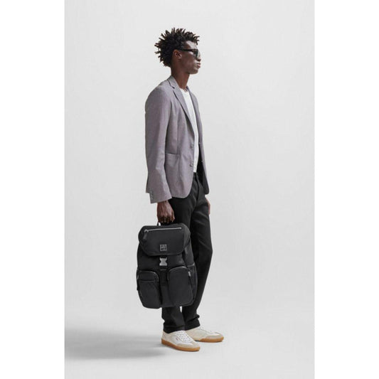 Flap-closure backpack with logo patch